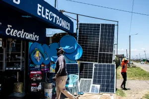 A man walks into a store where there are solar panels for sale in Nyeri, Kenya.
