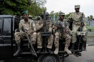 M23 rebels sit on a truck while escorting alleged captured FDLR members to Rwanda for repatriation, on 1 March 2025.