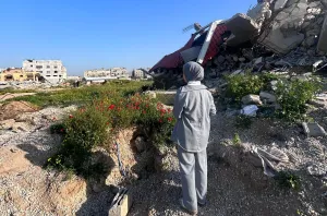 Nour overlooks her neighbourhood after returning to Gaza City during the ceasefire after spending over a year forcibly displaced.