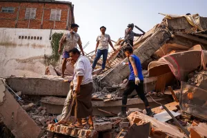 Rescuers work at the site of a building that collapsed, in the aftermath of a strong earthquake, in Mandalay, Myanmar, March 30.