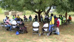 Refugee leaders sit outdoors at a meeting in Mpevi, western Uganda. R