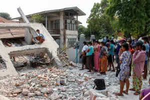 People stand by a collapsed building after a strong earthquake, near its epicenter, in Sagaing, Myanmar, March 31, 2025. 