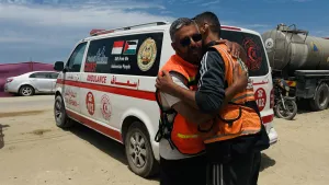 Ahmed Radwan, the leader of a brigade of Palestinian firefighters, hugs one of his team members (Walid al-Khaldy, 41) at the group’s base in the Gaza Strip's al-Mawasi region.