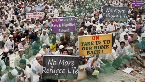 Rohingya refugees hold placards while attending a Ramadan Solidarity Iftar to have an Iftar meal with United Nations Secretary-General Antonio Guterres and Muhammad Yunus, Chief Adviser of Bangladesh Interim Government, at the Rohingya refugee camp in Cox's Bazar, Bangladesh, March 14, 2025.