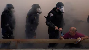 Police officers look at a demonstrator during a protest against federal immigration sweeps in downtown Los Angeles, June 8.