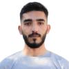 This is a headshot of Laith Doghim. He's a photojournalist working in northwest Syria, covering the humanitarian crisis, and events in the region. He's pictured facing the camera with a calm expression. He wears a gray t-shirt.