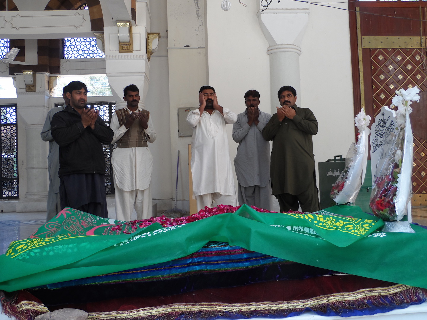 Devotees pray at the burial chamber in the Bari Imam Sufi shrine in Islamabad