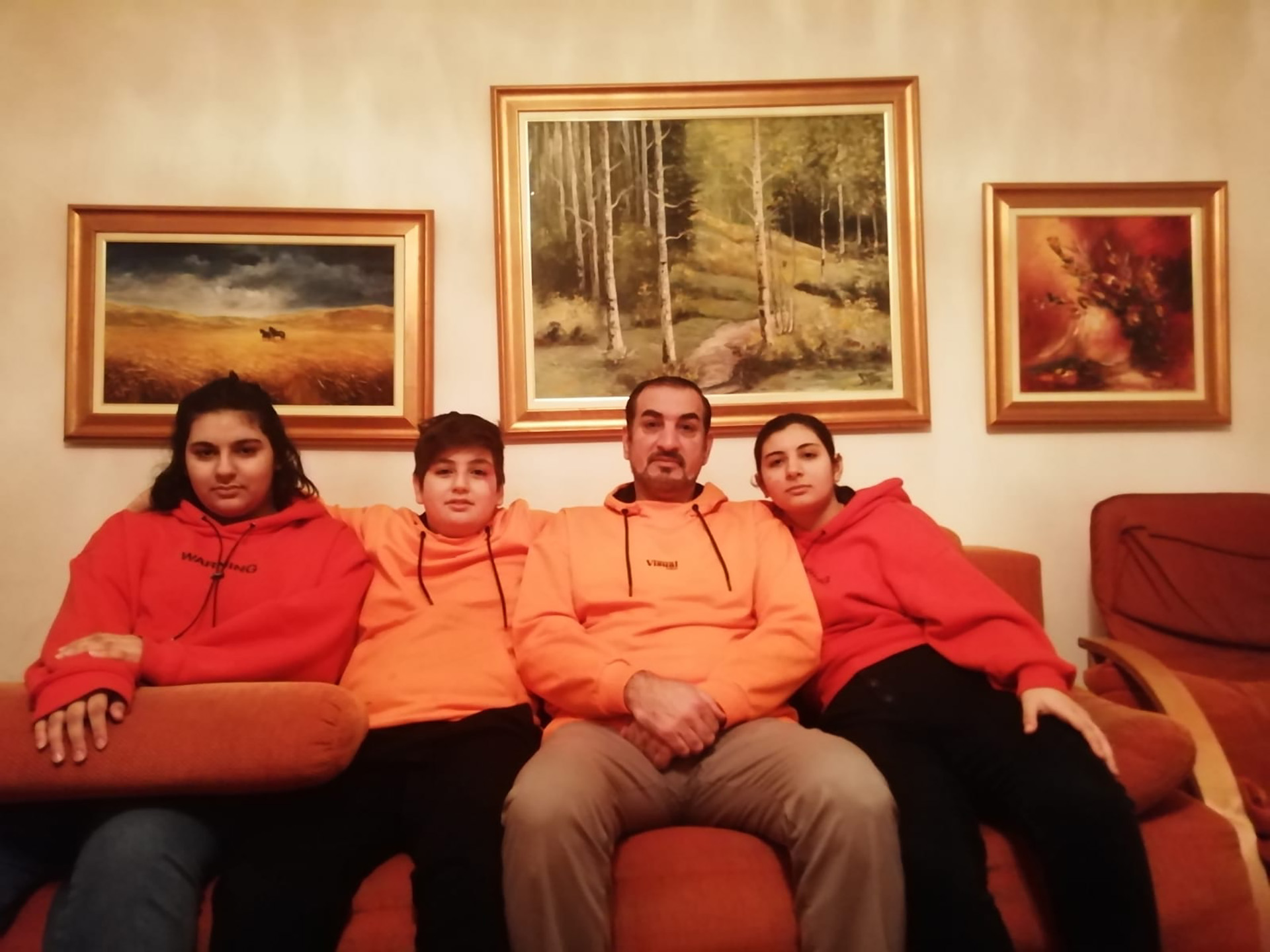 From right to left, Nimet, 17, Mohammad, 47, Yousef, 13, and Hikmet, 15, in the living room of their old apartment in Sarajevo.