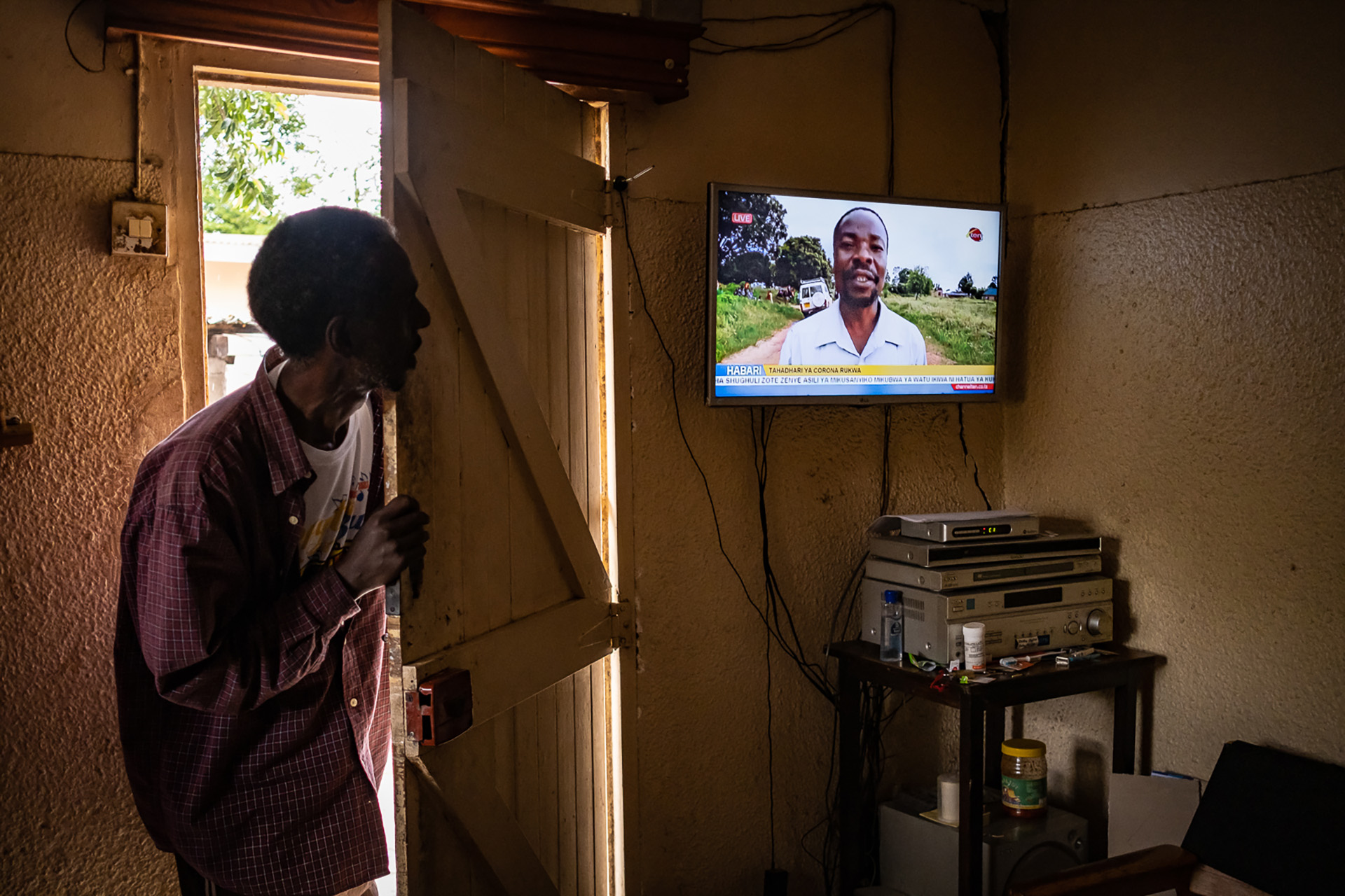 Hassan Mohammad peers at the TV at his home