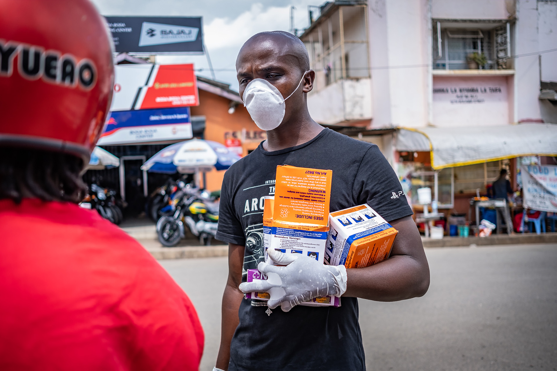 A man sells masks and gloves in Arusha city