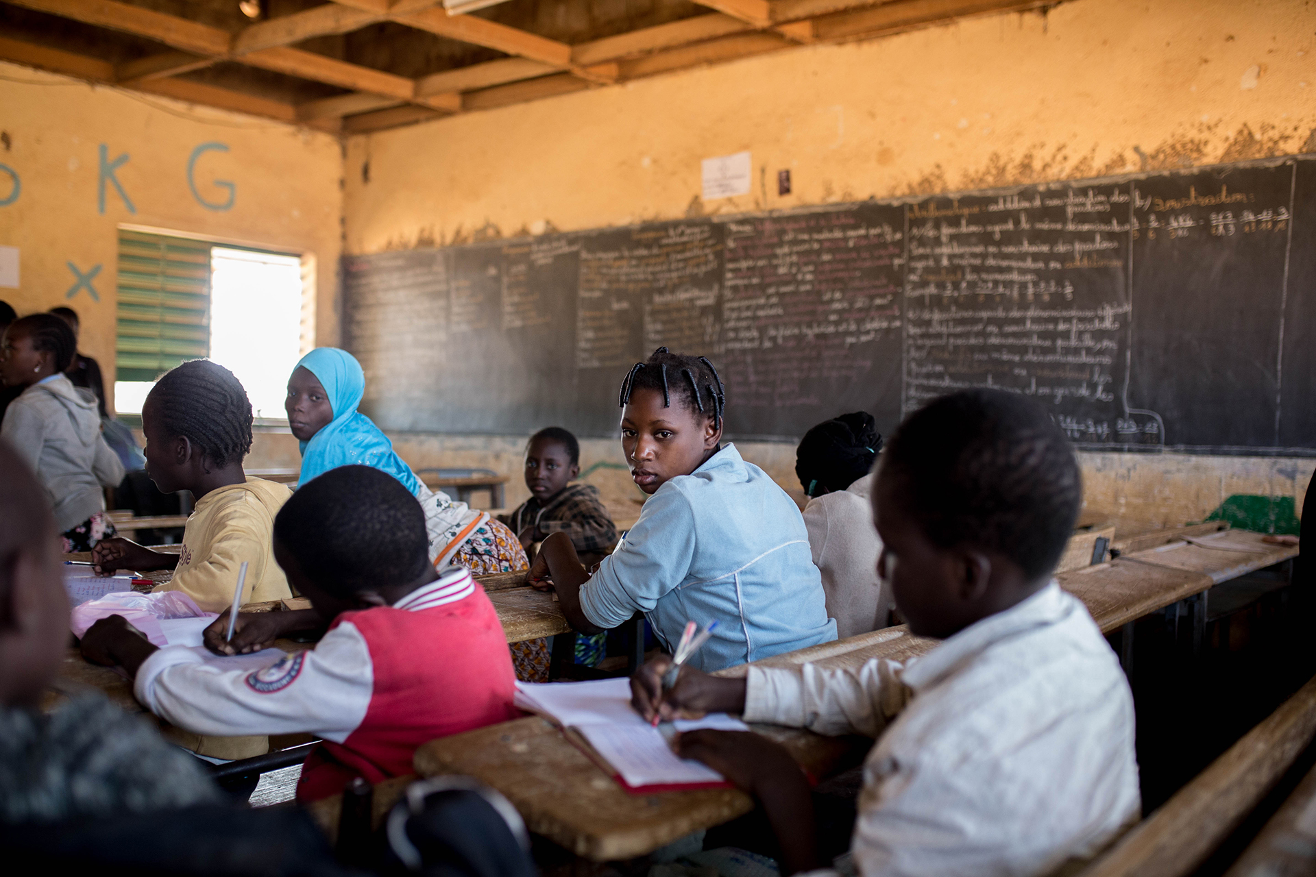 Students in a classroom with a chalkboard