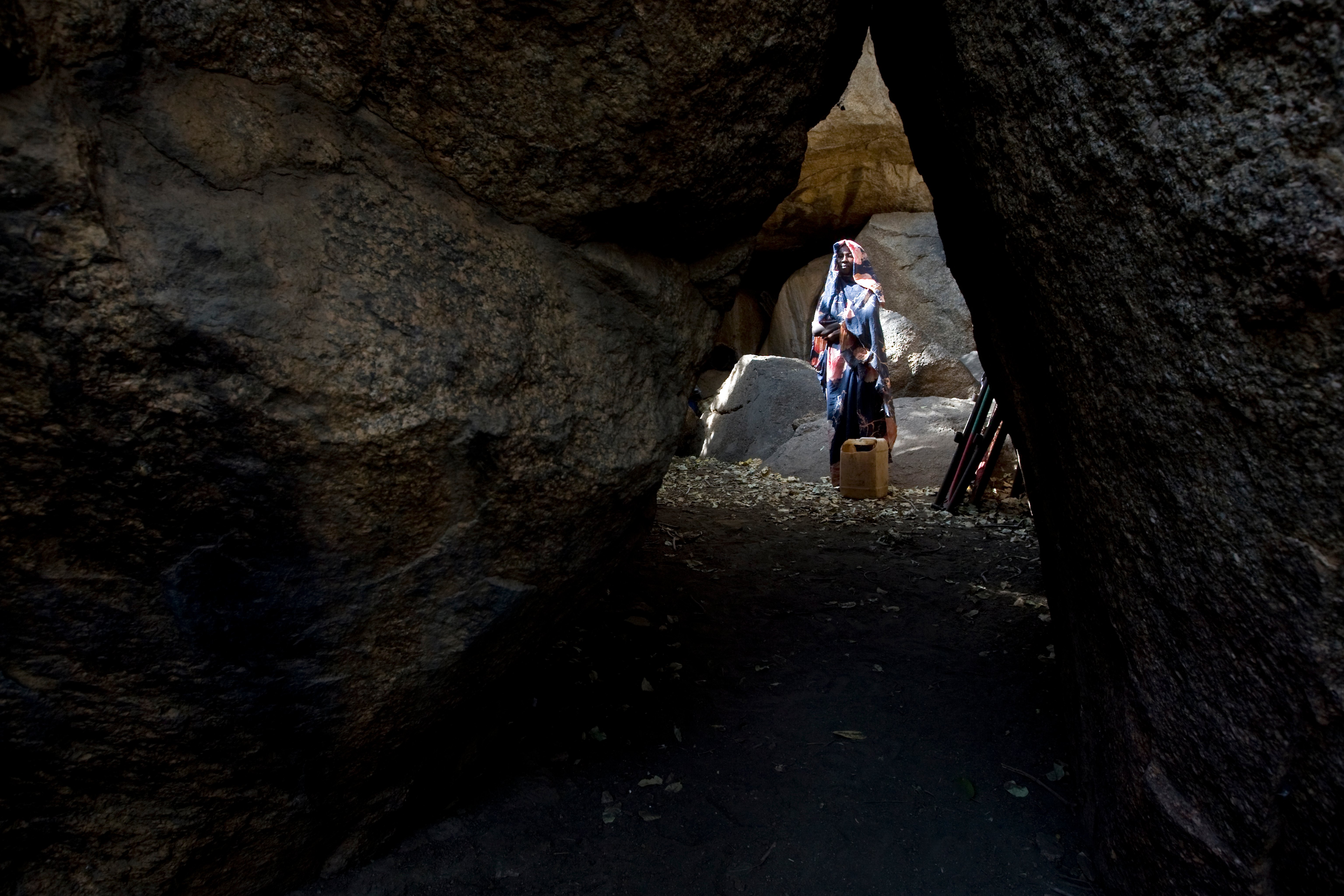 A Nuban woman hides in a cave