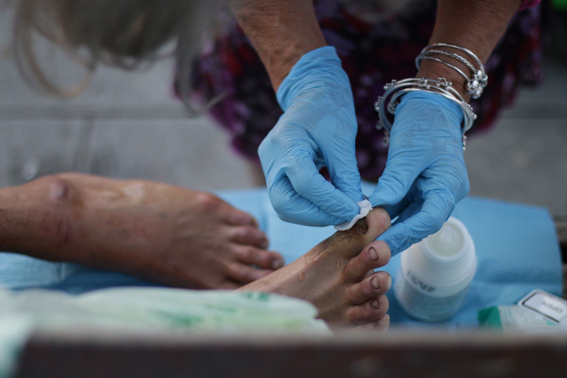 Local volunteers offer assistance to the dozens of asylum seekers and migrants from Pakistan and Afghanistan sleeping rough in Trieste, many of whom have badly swollen feet