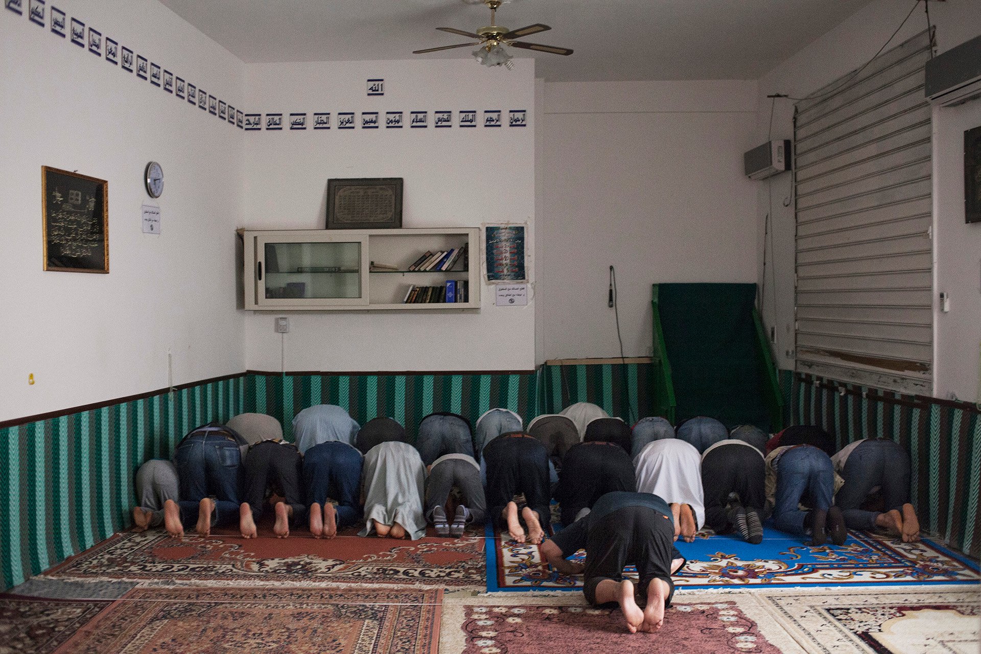 Tunisian worshippers pray in a makeshift mosque inside a former shop in a neighbourhood called the Kasbah in Mazara del Vallo.