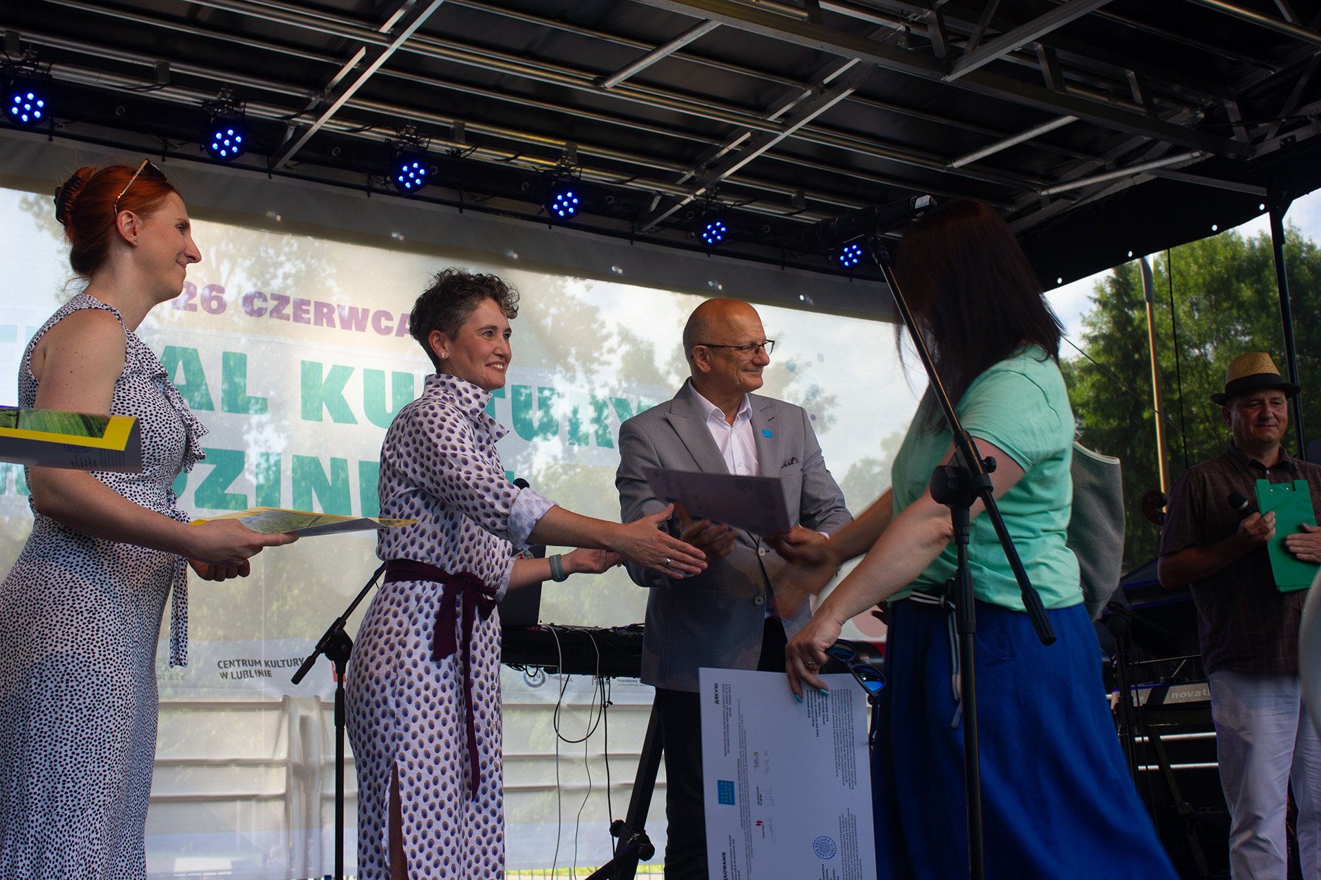 Anna Dąbrowska, from the Polish human rights organisation Homo Faber, hands out certificates of appreciation to volunteers involved in efforts to help Ukrainian refugees in the city of Lublin on 26 June.