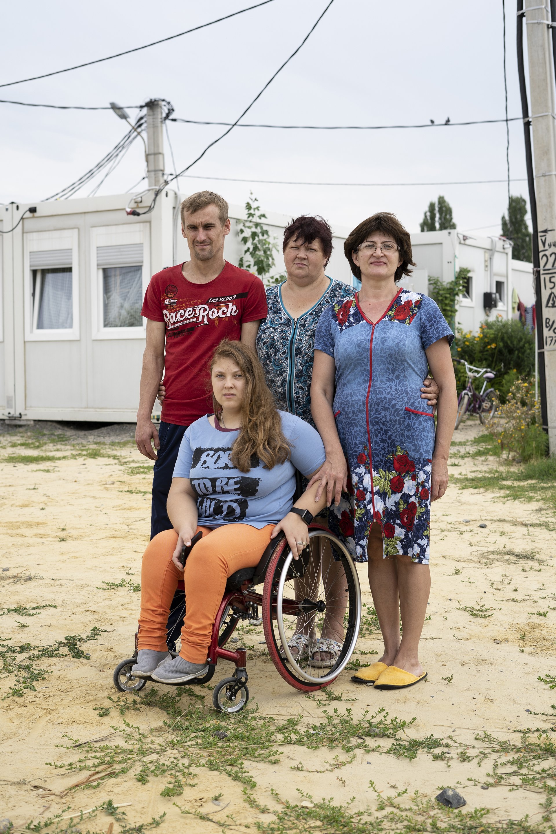 Portrait of family outside of the rooms of a displaced persons centre in east Ukraine.