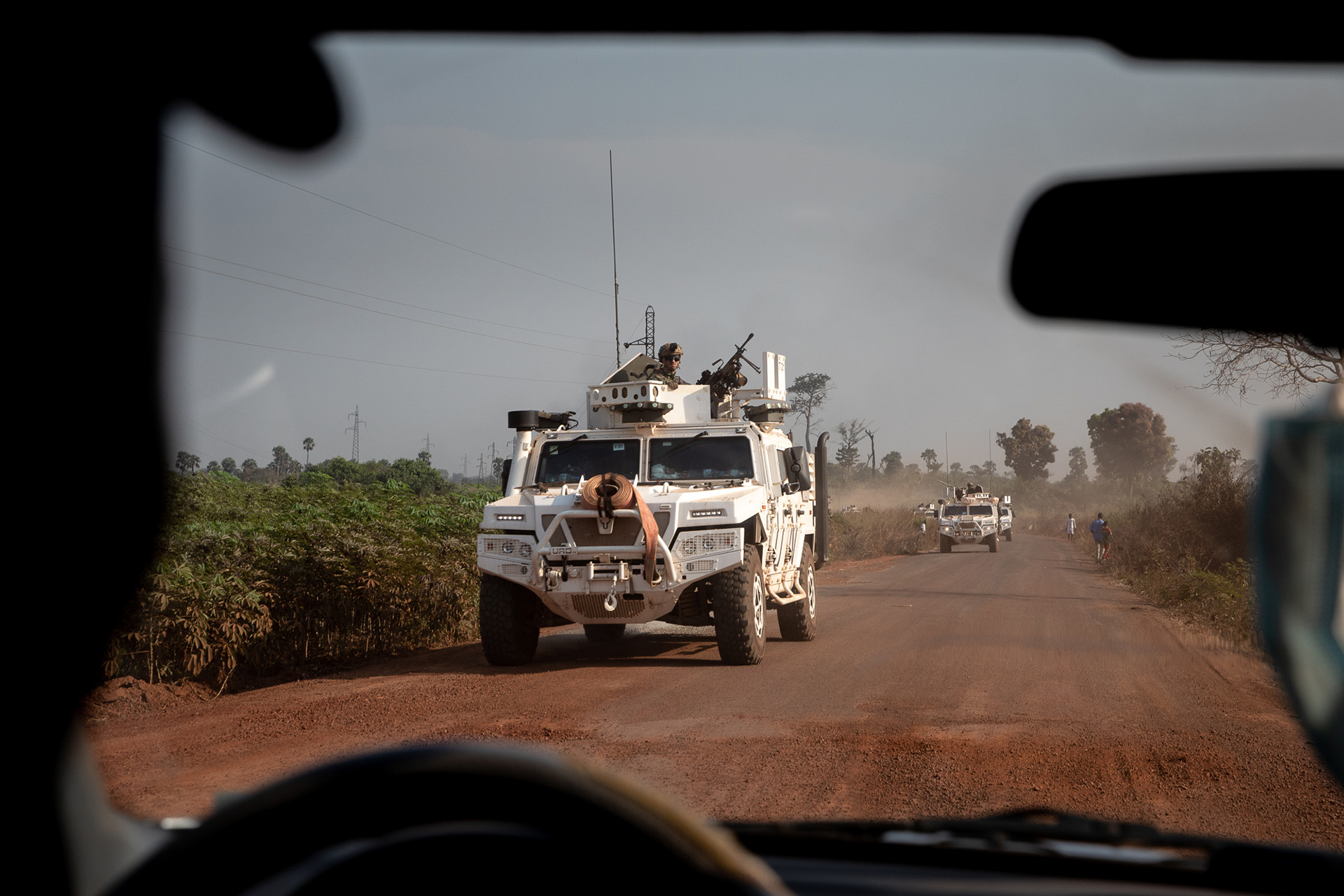 A UN peacekeeper patrol truck is seen through another vehicles windshield. 