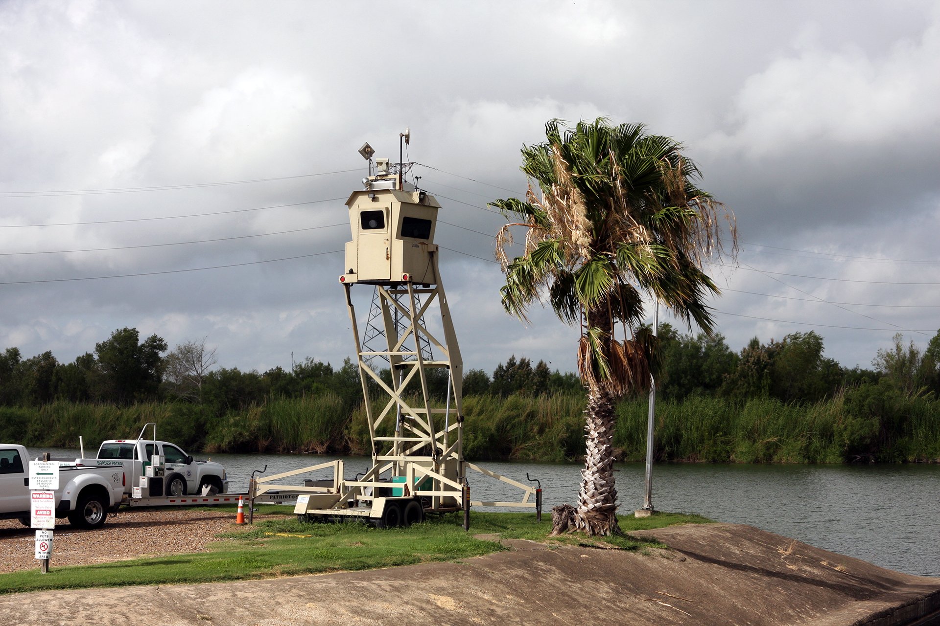 Photo of border patrol in Texas looking at Mexico.