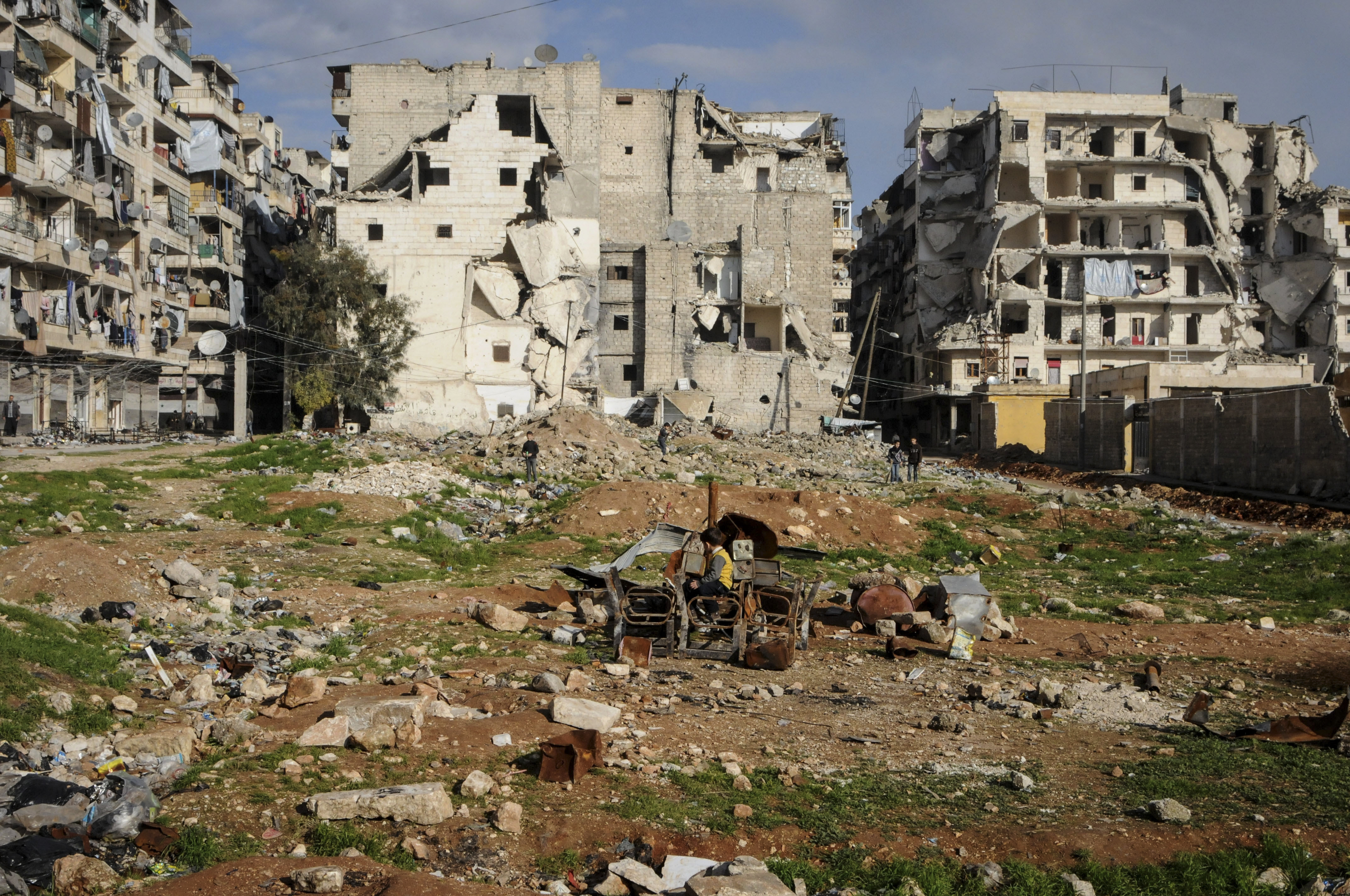 Outskirts of Aleppo. Kids playing with burnt chairs.