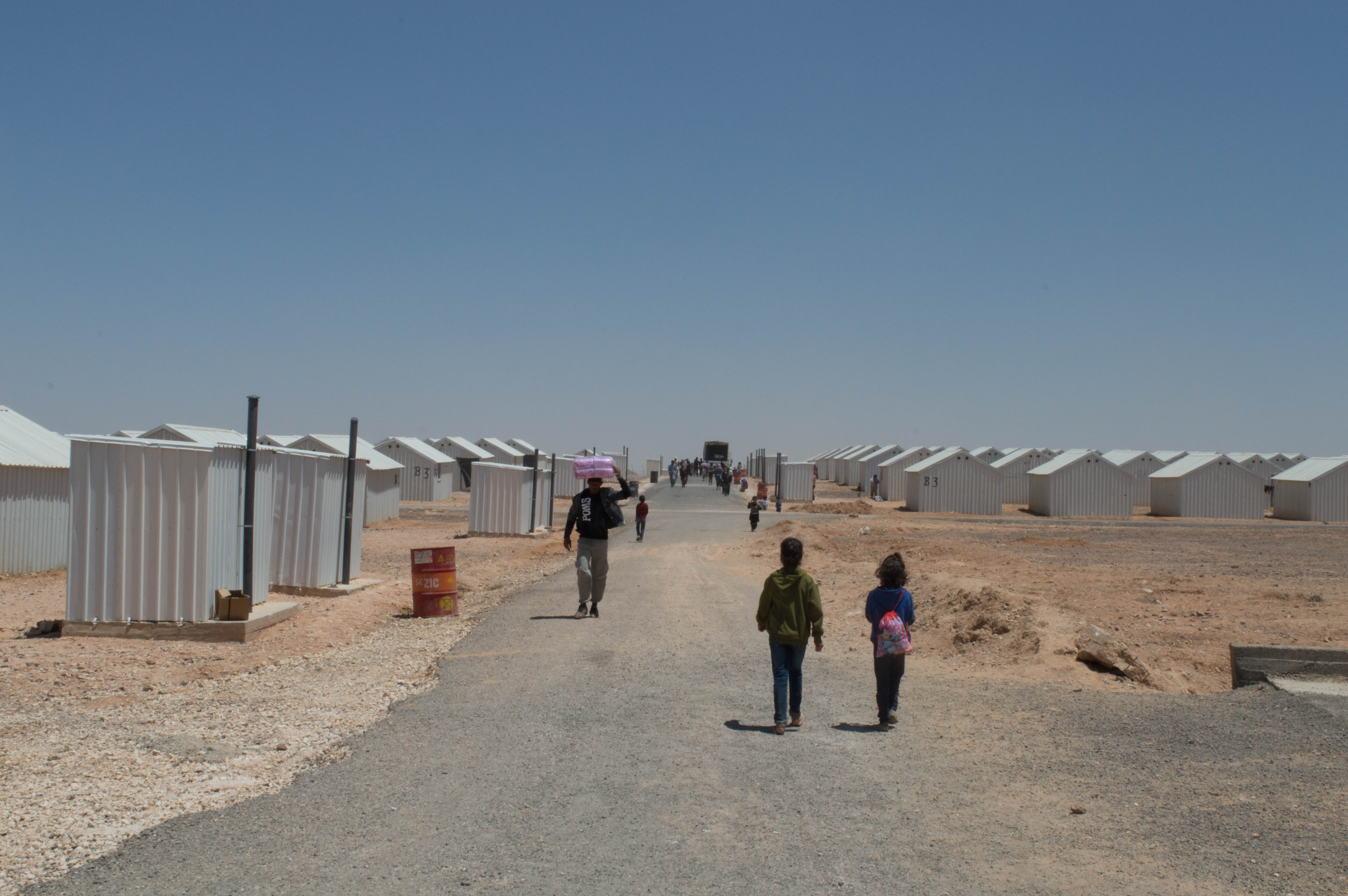 Children walking in a refugee camp