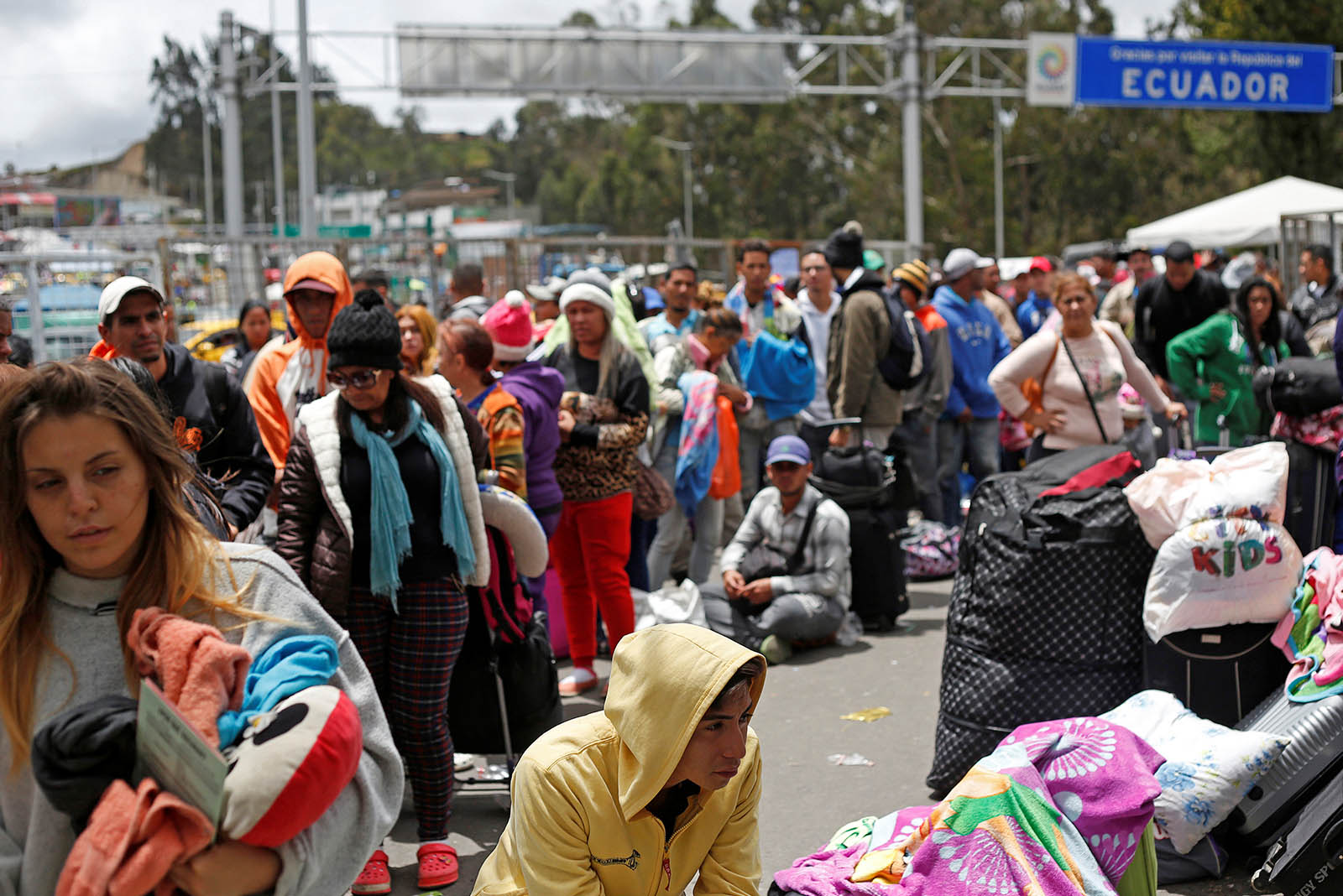 Venezuelan citizens and other migrants wait at the border with Colombia.