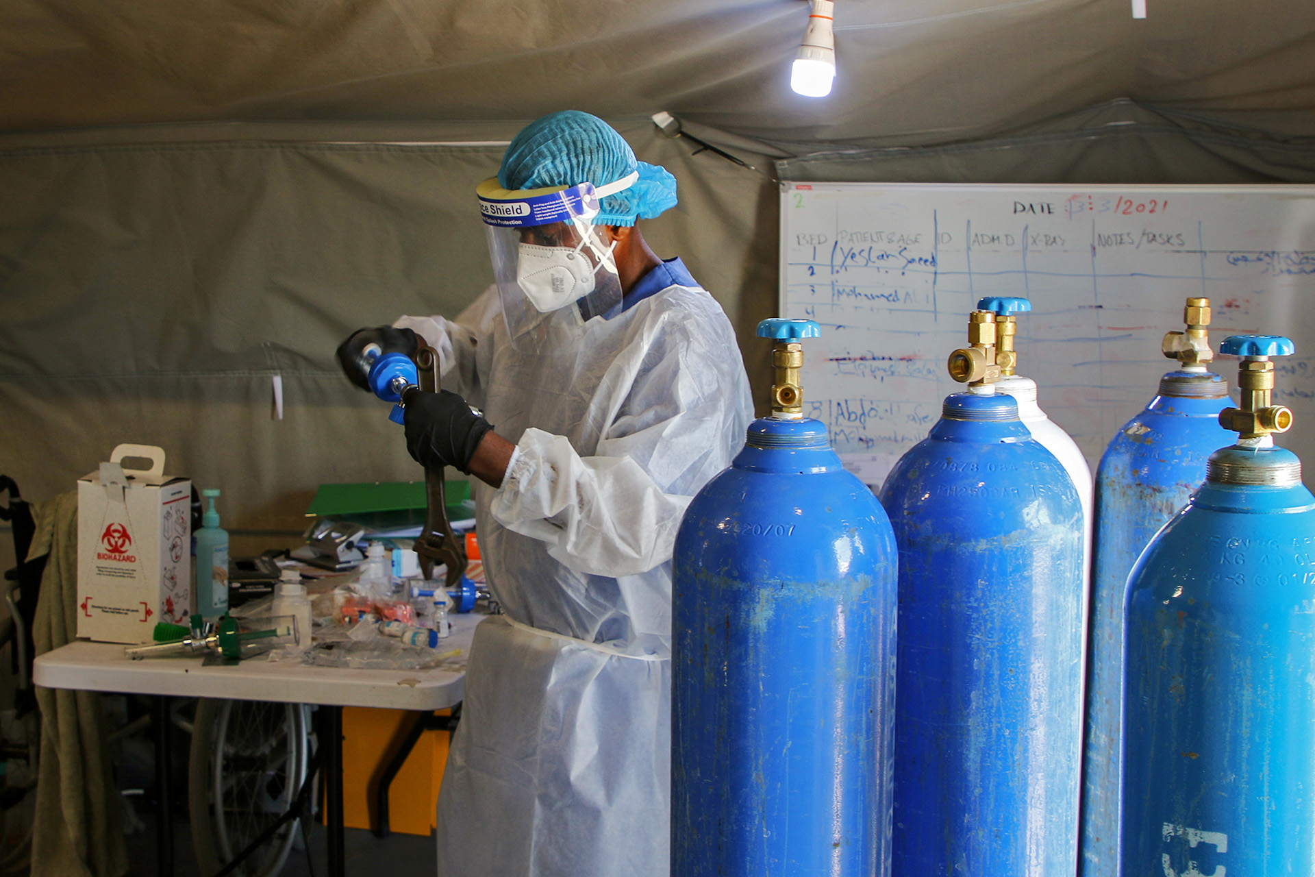 A worker prepares oxygen cylinders at a COVID-19 quarantine centre in Aden, south Yemen, on 27 March  2021.A worker prepares oxygen cylinders at a Covid-19 quarantine centre in Aden, Yemen March 27, 2021.